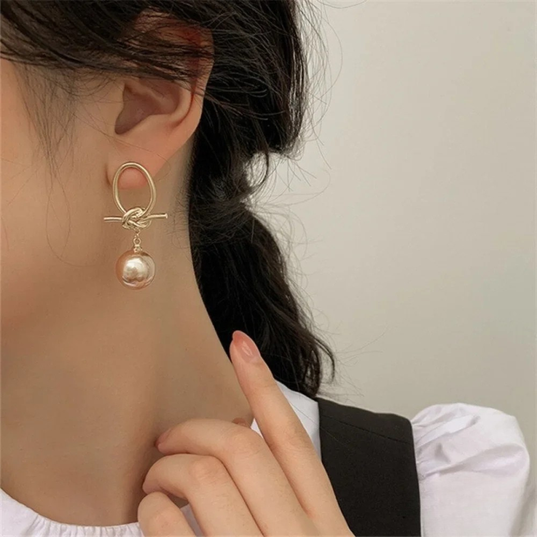 Boucles d’oreilles anneaux dorés avec perle